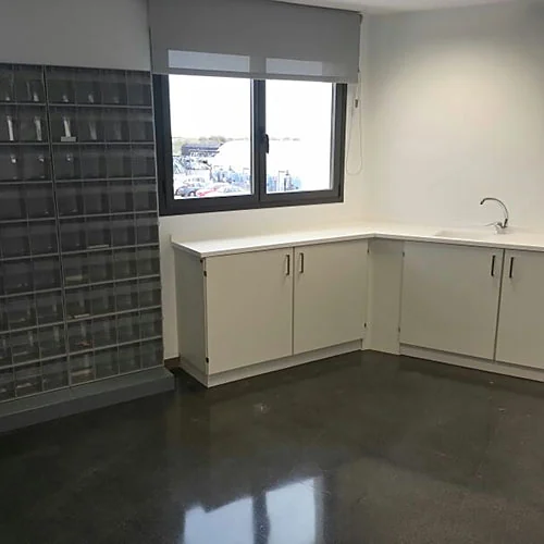 L-shaped solid surface worktop next to the bin cabinets