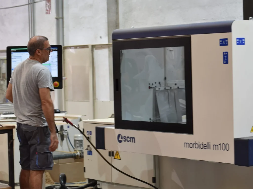 Operator next to the SCM Morbidelli m100 CNC machining centre in the Eban Premium factory