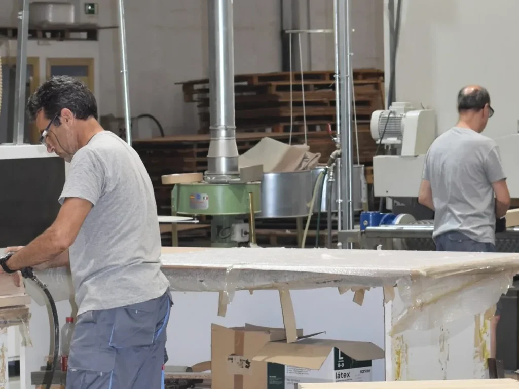 Two cabinetmakers at work in the Eban Premium factory in Silla (Valencia, Spain)